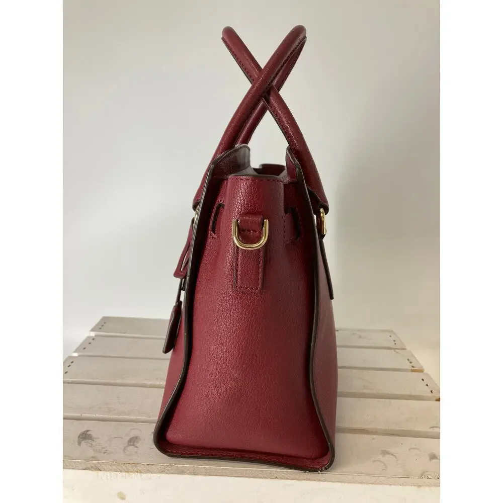MICHAEL KORS, LARGE WINE LEATHER HANDBAG WITH LOCK CHARM.